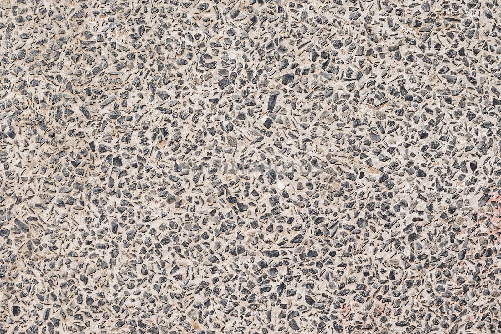 Stone background made of a closeup of a pile of pebbles