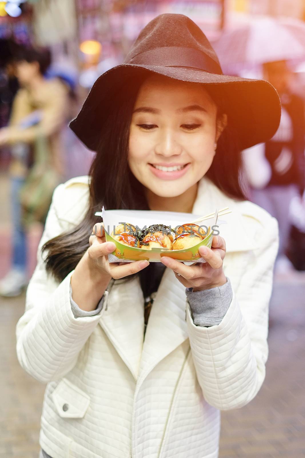 Chinese Asian young female model eating dumpling batter (Takoyak by Surasak
