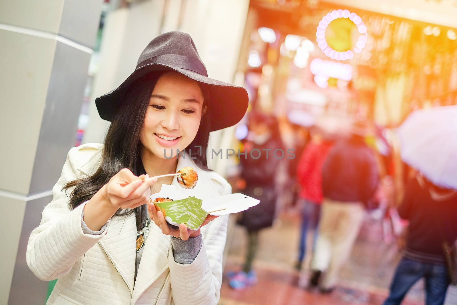 Chinese Asian young female model eating dumpling batter (Takoyak by Surasak
