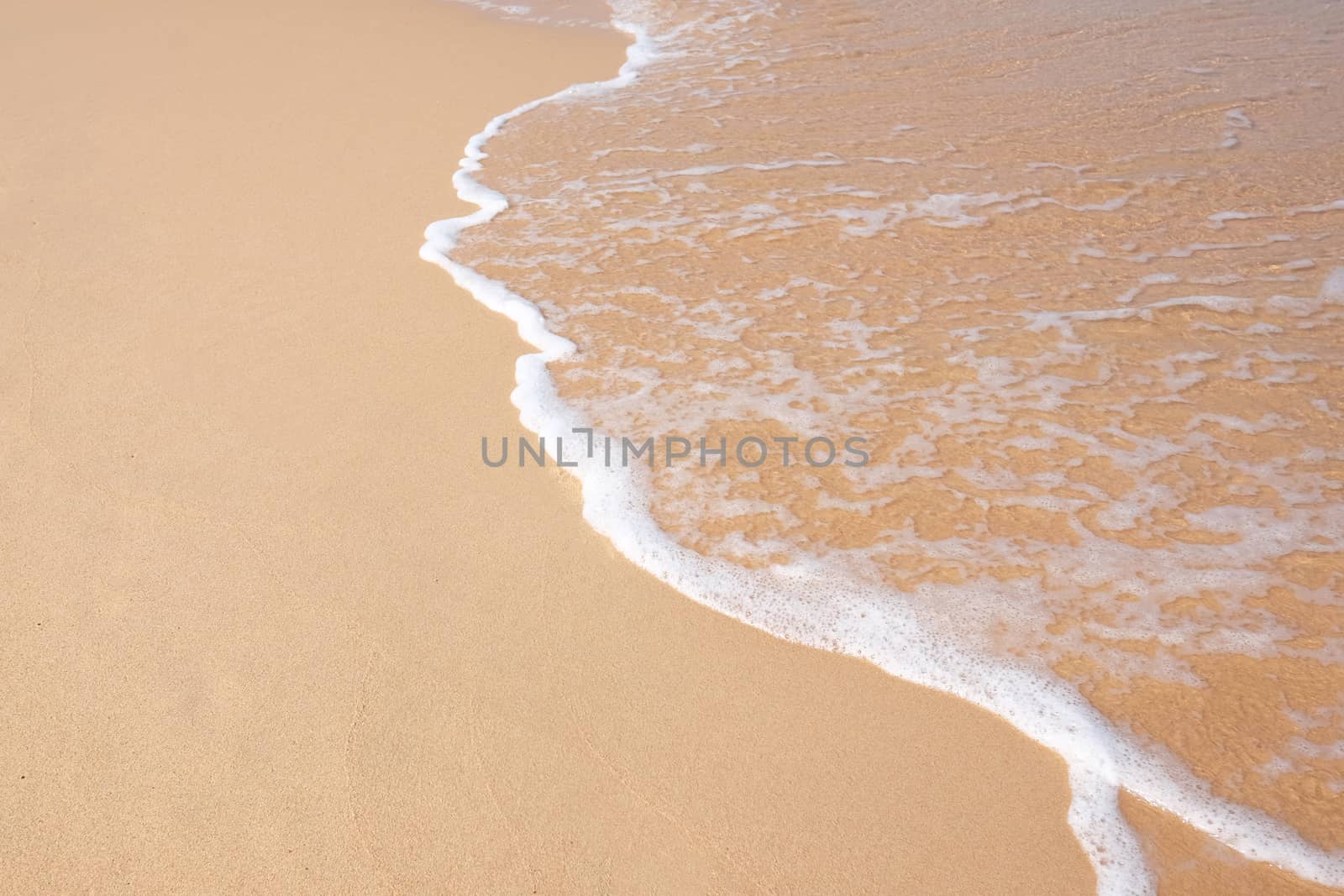 Wave on the sand beach by Surasak
