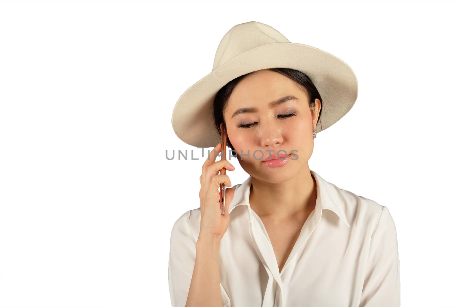 young attractive asian woman waiting answer for a smart phone on white backgroud 