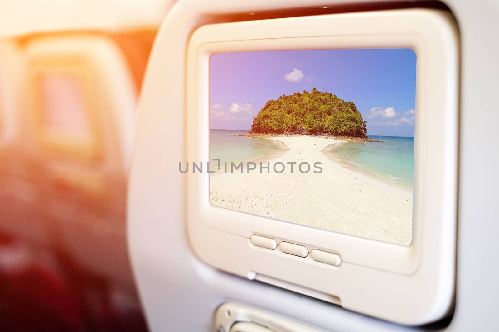 Aircraft monitor in front of passenger seat showing Miracle beach & crystal clear water at Koh Kai, Koh Tub & Koh Mor, Krabi, Thaiand.