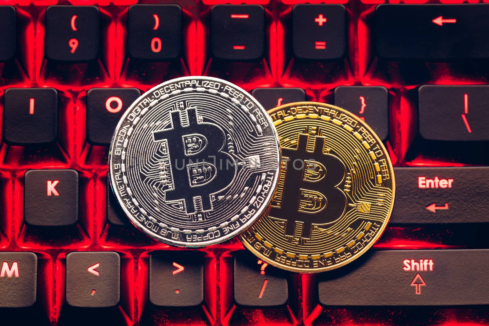 Bitcoin on compuer keyboard in background, symbol of electronic virtual money and mining cryptocurrency concept. Coin crypto currency bitcoin lies on the keyboard. Bitcoin on keyboard.