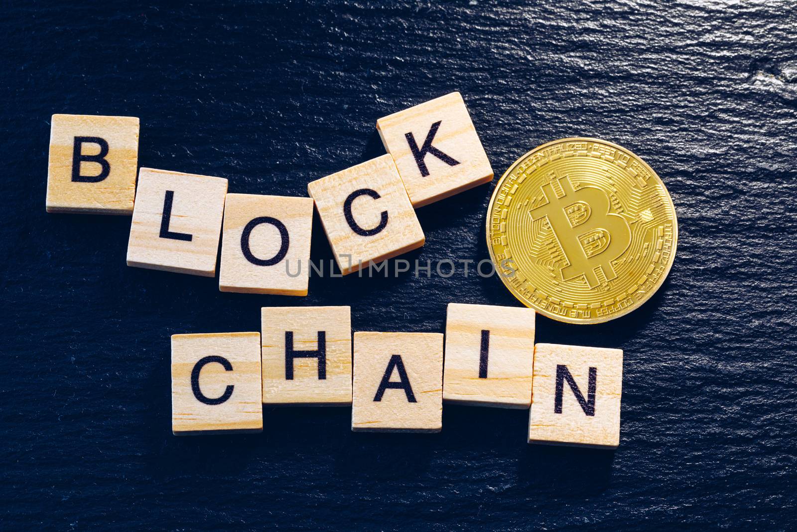 Bitcoins money Virtual currency concept background. Golden bitcoin coin blockchain technology for crypto currency. Digital money currency. Small wooden blocks with block chain text on them.