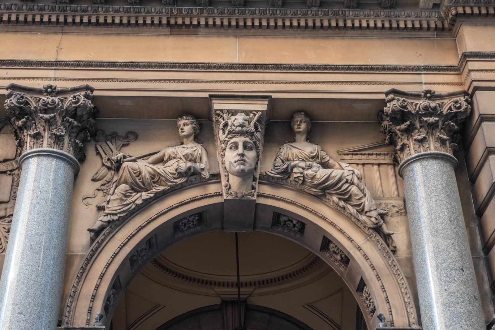 Sydney, Australia - February 12, 2019: Historic and Iconic General Post Office building facade on corner of Martin Place and , George Street. Classical alegorical figures statue above spandrel.