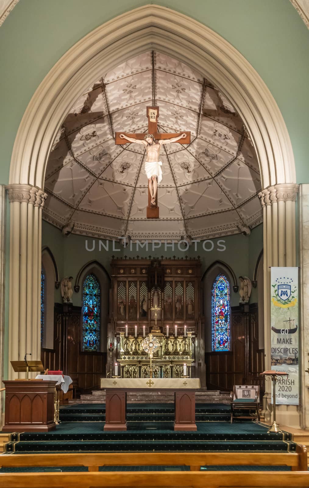 Sydney, Australia - February 12, 2019: Inside Saint Patricks Church on Grosvenor Street opposite of Lang Park. The Chancel with altar and Jesus Christ on the cross hanging from ceiling.