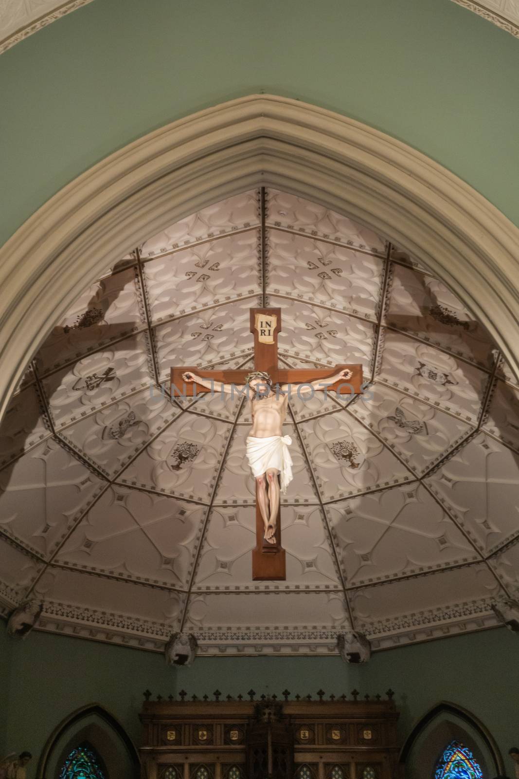 Jesus Christ on the cross in Saint Patricks Church, Sydney Austr by Claudine