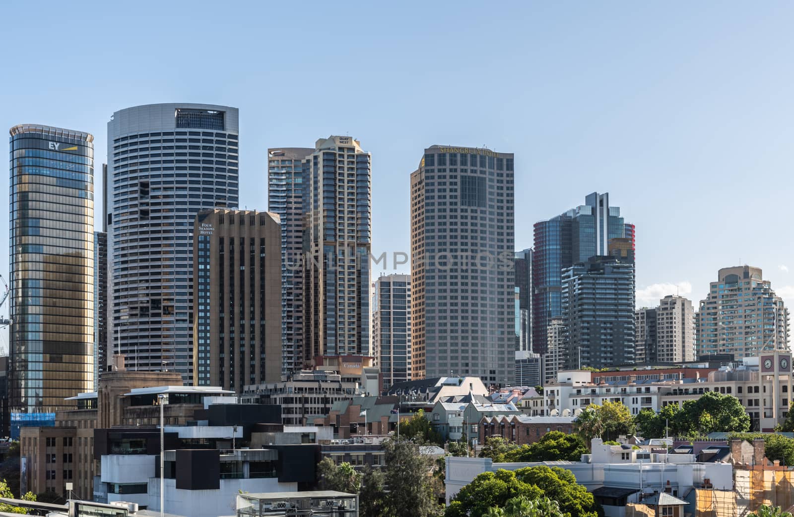 Sydney, Australia - February 12, 2019: Skyline of The Rocks with highrises west of Circular Bay featuring hotels such as Shangri-la and Four Seasons. Evening shot from dock at Circular Bay.