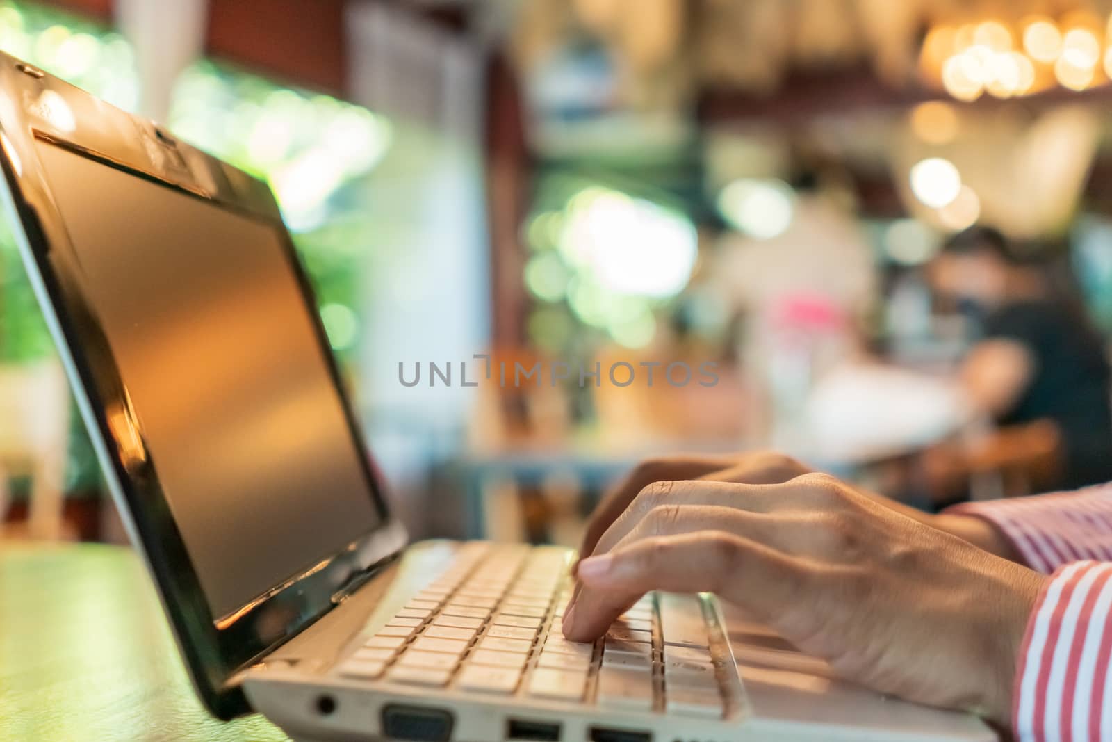 Woman hand using laptop to work study on work desk with clean nature background background. Business, financial, trade stock maket and social network. by Suwant