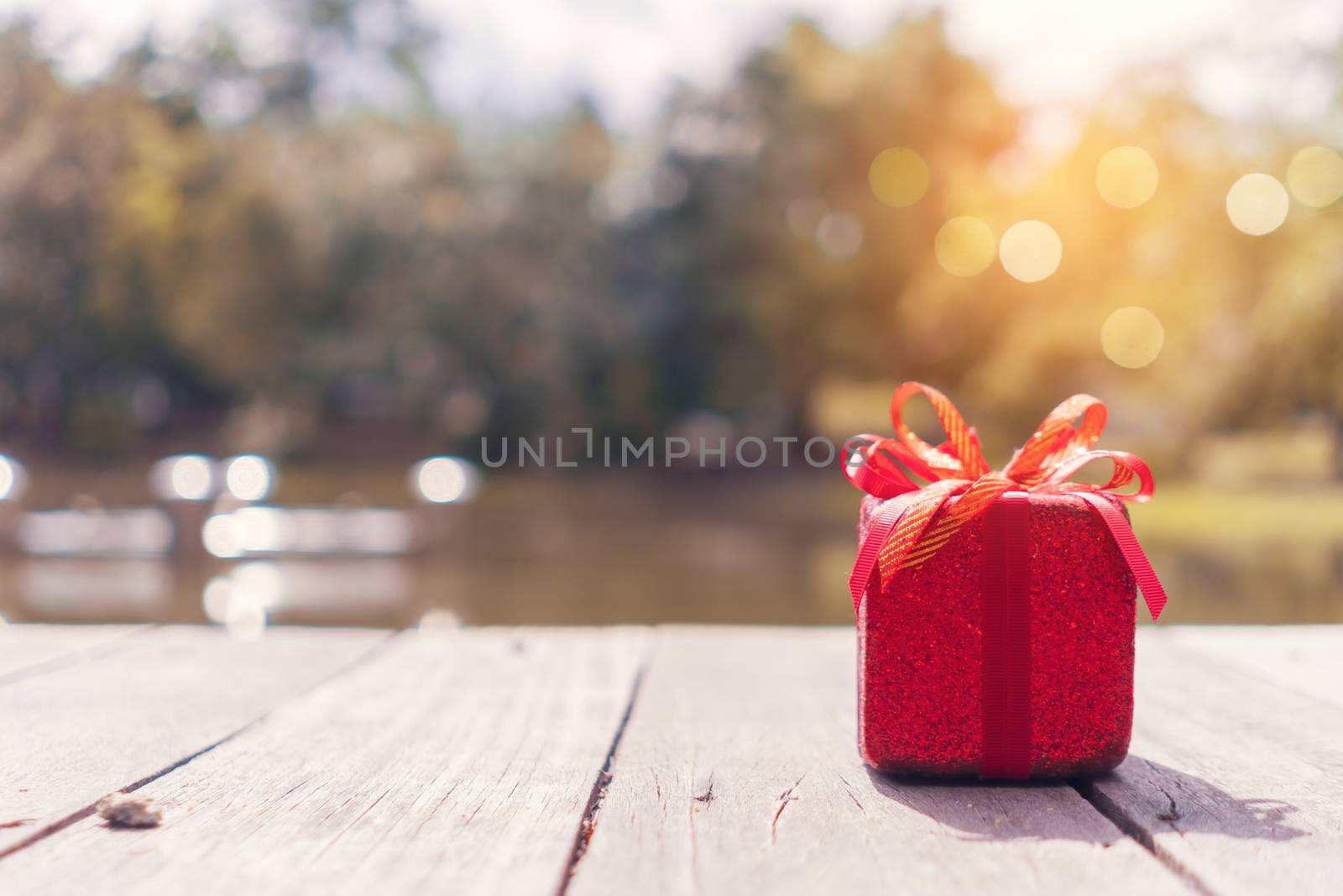 Gift boxes on green bokeh nature background. by Suwant