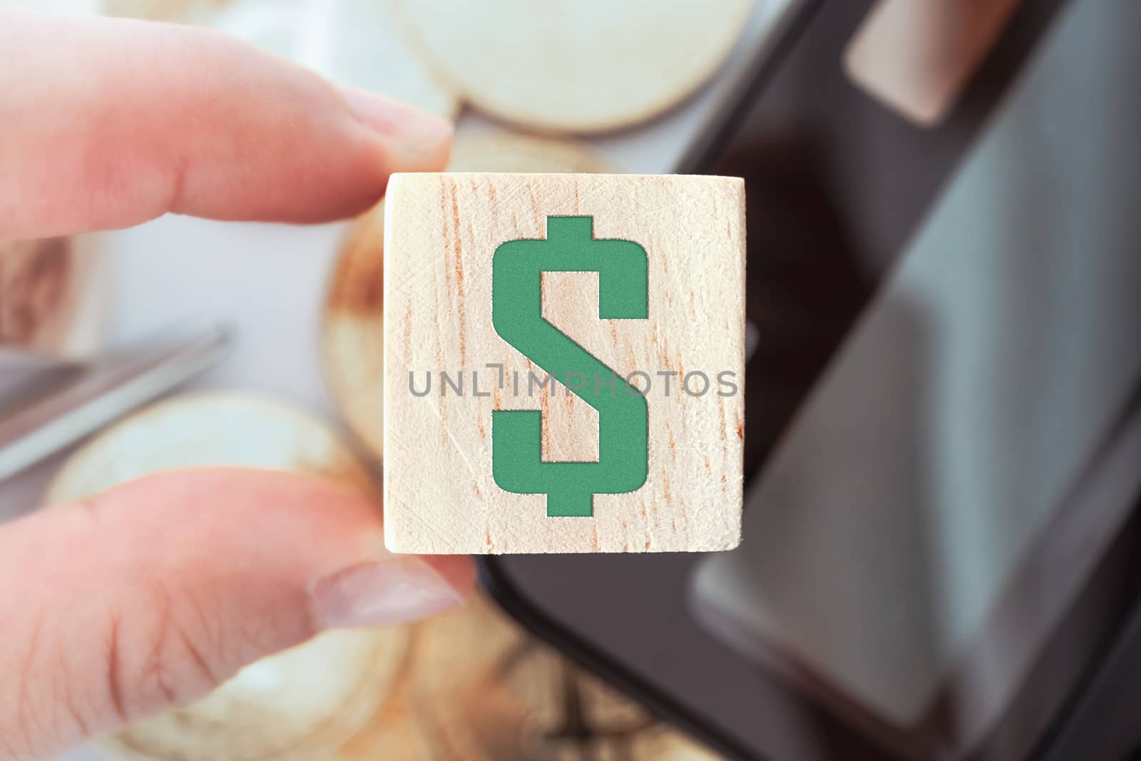 Dollar sign letterpress design on wooden cube decorate with calculator stationary gold coin. Business financial investing home property concept.