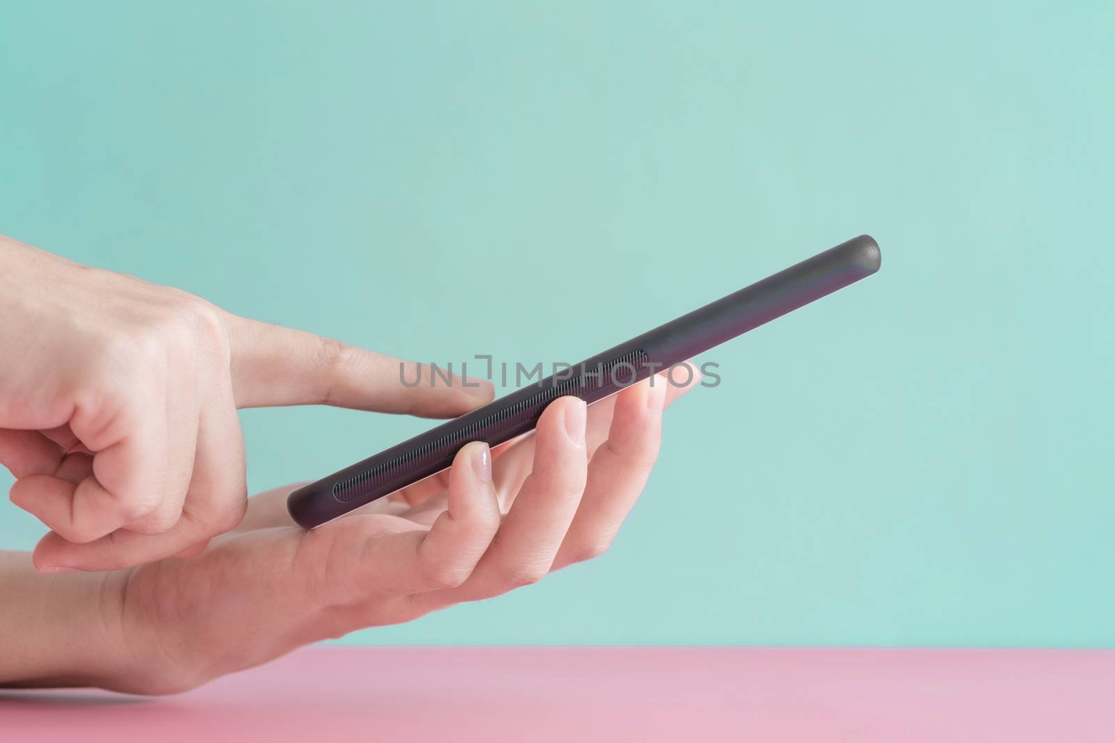 People hand using smartphone with blank pastel clear background. Business, financial, trade stock maket and social network. by Suwant