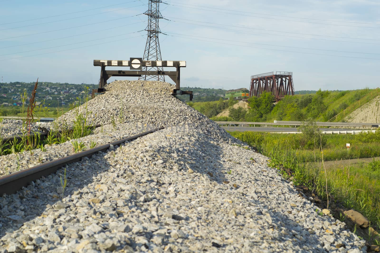 Railway impasse on the railroad tracks. View of the bridge with a railway locomotive