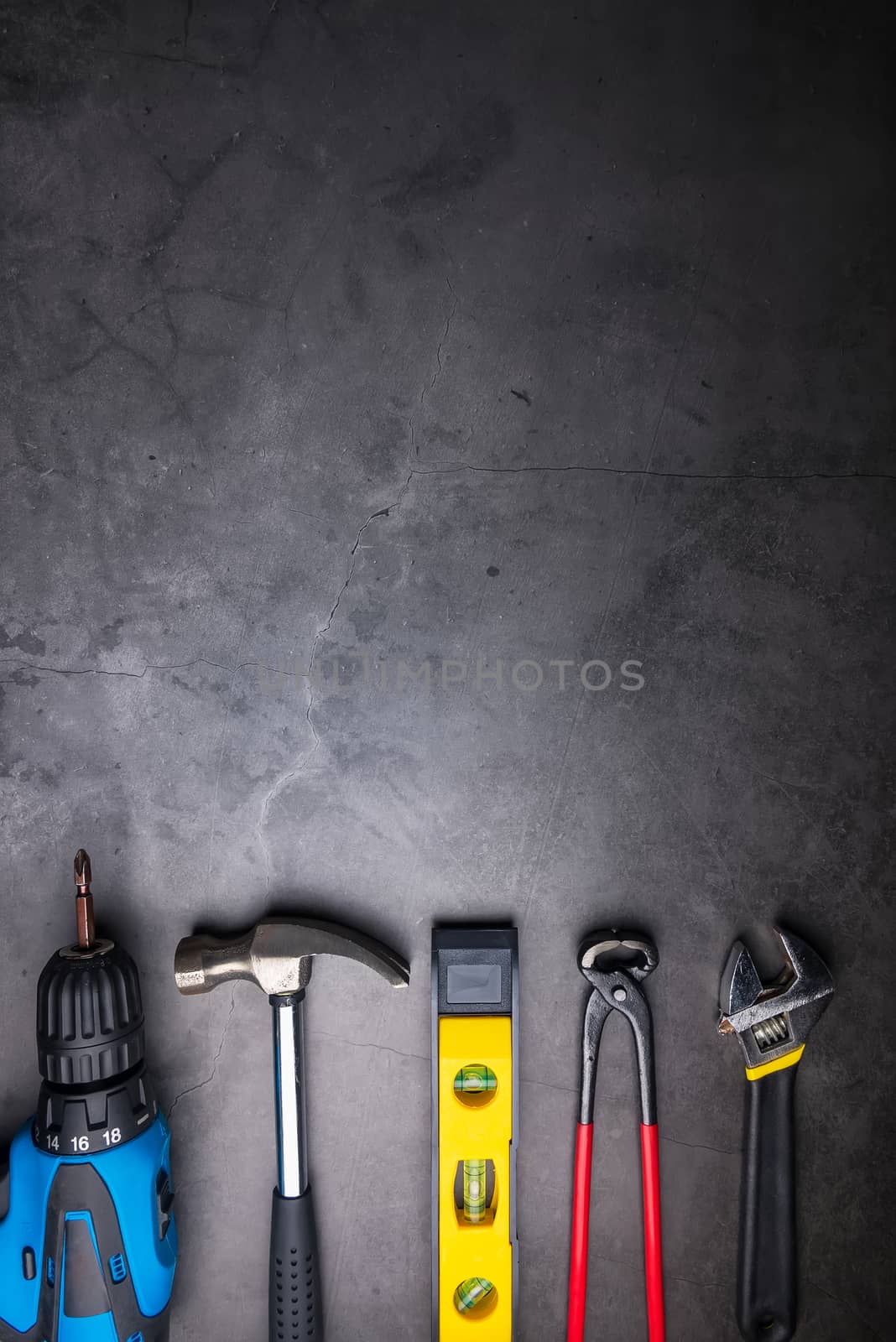 Home Repair Hand Tools on a cement gray background. Concept home by Bubbers