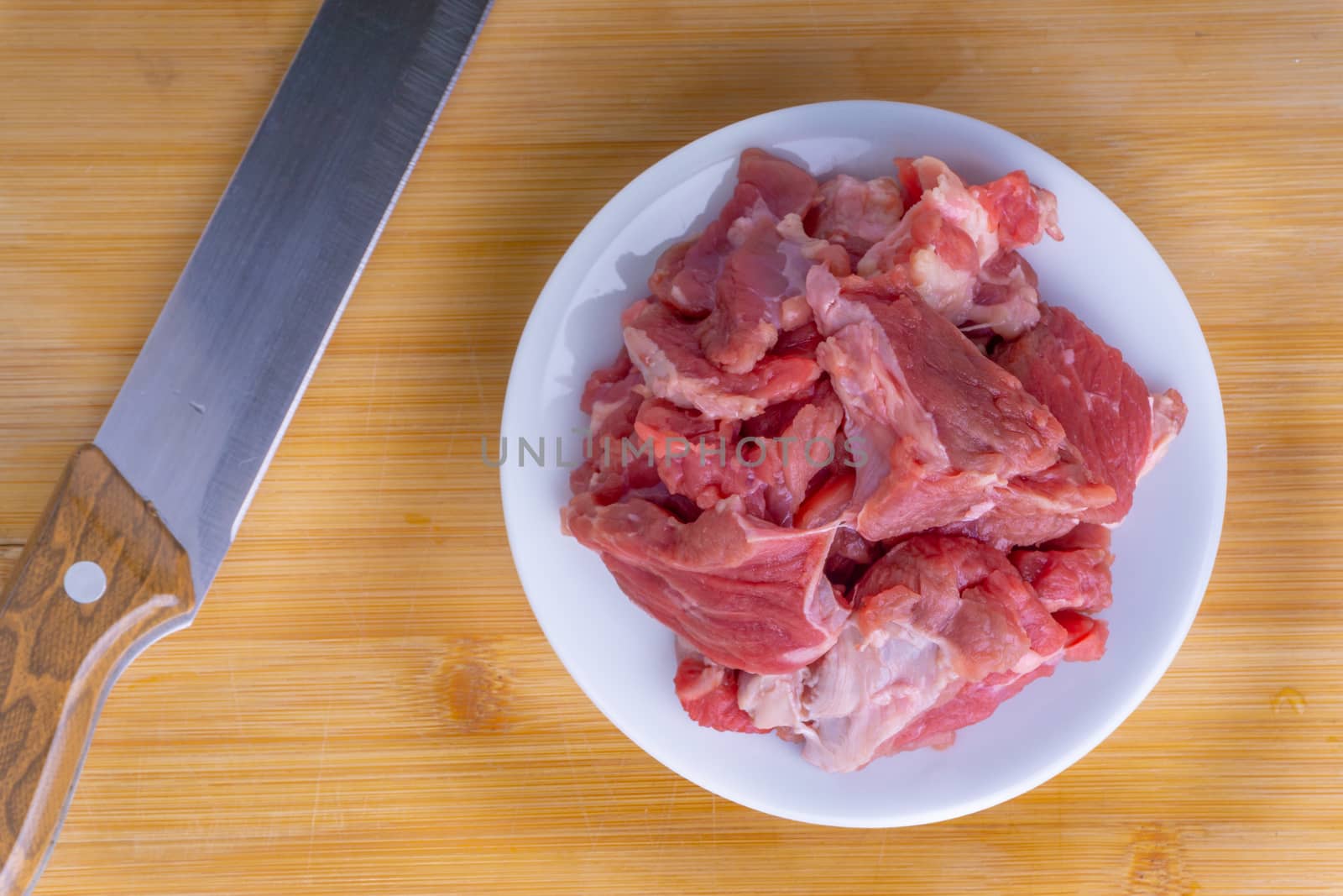 Fresh raw beef steak on wooden background with selective focus by silverwings