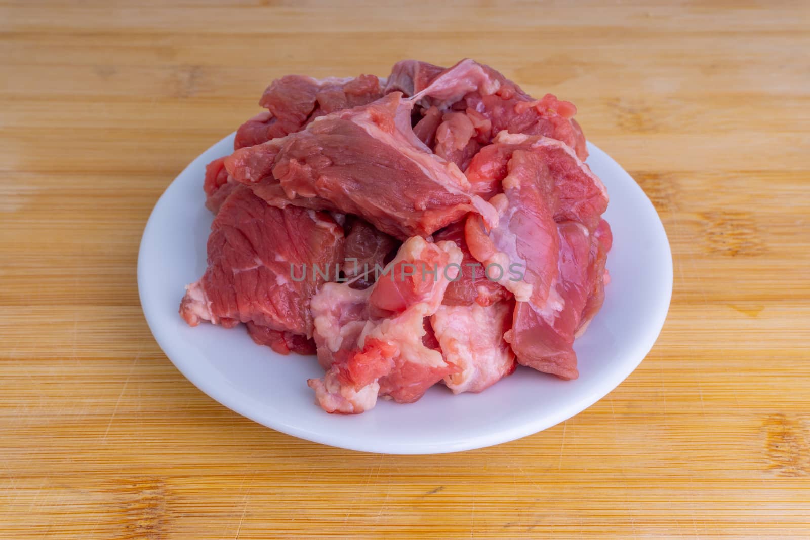 Fresh raw beef steak on wooden background with selective focus