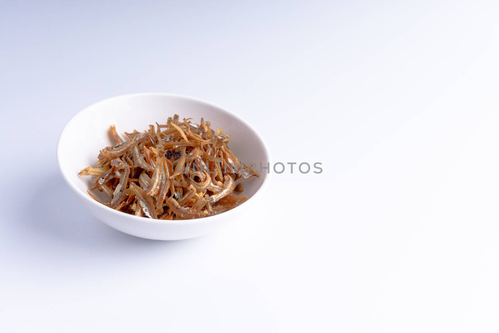 Fried anchovies in bowl close up by silverwings