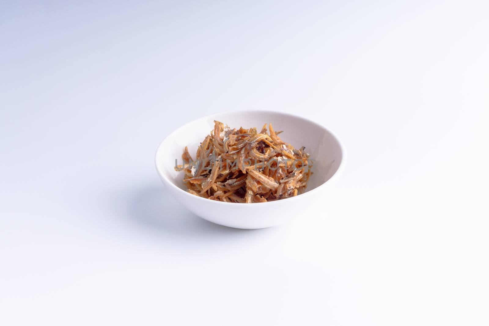 Fried anchovies in bowl close up by silverwings