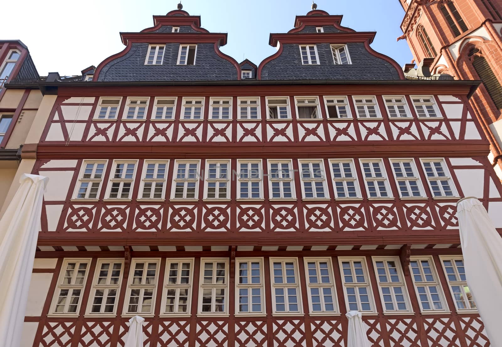 FRANKFURT AM MAIN, GERMANY - JULY 2, 2015: Buildings of Roemerberg square in Frankfurt, Germany. Frankfurt is the fifth-largest city in Germany.

Frankfurt am Main, Germany - July 2, 2015: Buildings of Roemerberg square in Frankfurt, Germany. Frankfurt is the fifth-largest city in Germany.