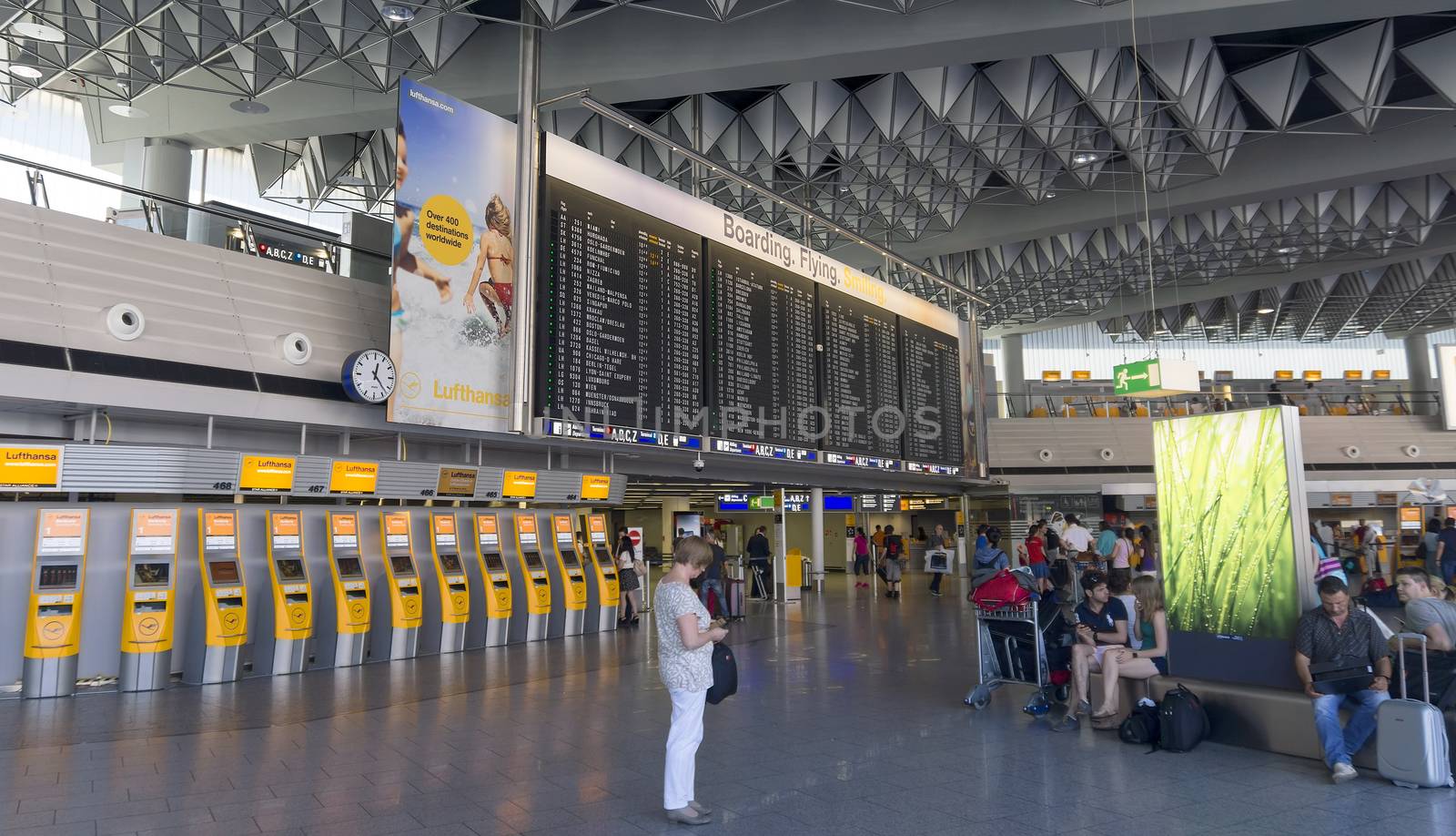 FRANKFURT AM MAIN, GERMANY - JULY 2, 2015: Travelers at public area at international Frankfurt Airport, the busiest airport in Germany. Longer exposure.

Frankfurt am Main, Germany - July 2, 2015: Travelers at public area at international Frankfurt Airport, the busiest airport in Germany. In 2012, Frankfurt handled 57.5 million passengers. Longer exposure.