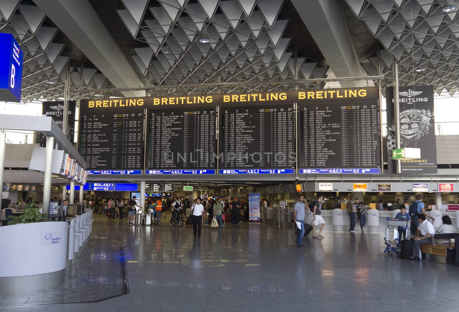 FRANKFURT AM MAIN, GERMANY - JULY 2, 2015: Travelers at public area at international Frankfurt Airport, the busiest airport in Germany. Longer exposure.

Frankfurt am Main, Germany - July 2, 2015: Travelers at public area at international Frankfurt Airport, the busiest airport in Germany. In 2012, Frankfurt handled 57.5 million passengers. Longer exposure.