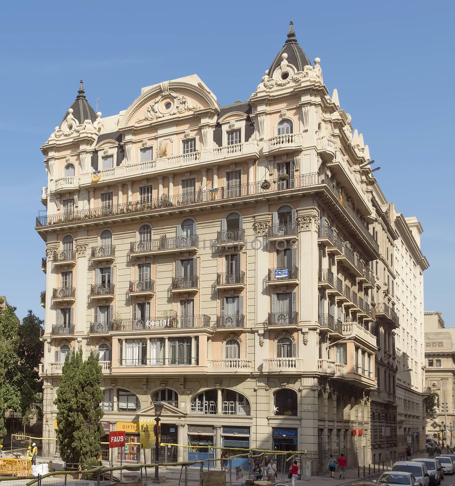 BARCELONA, SPAIN - JULY 6, 2015: Typical architecture of one urban district in Barcelona, Spain.

Barcelona, Spain - July 6, 2015: Typical architecture of one urban district in Barcelona, Spain. People are walking by street.