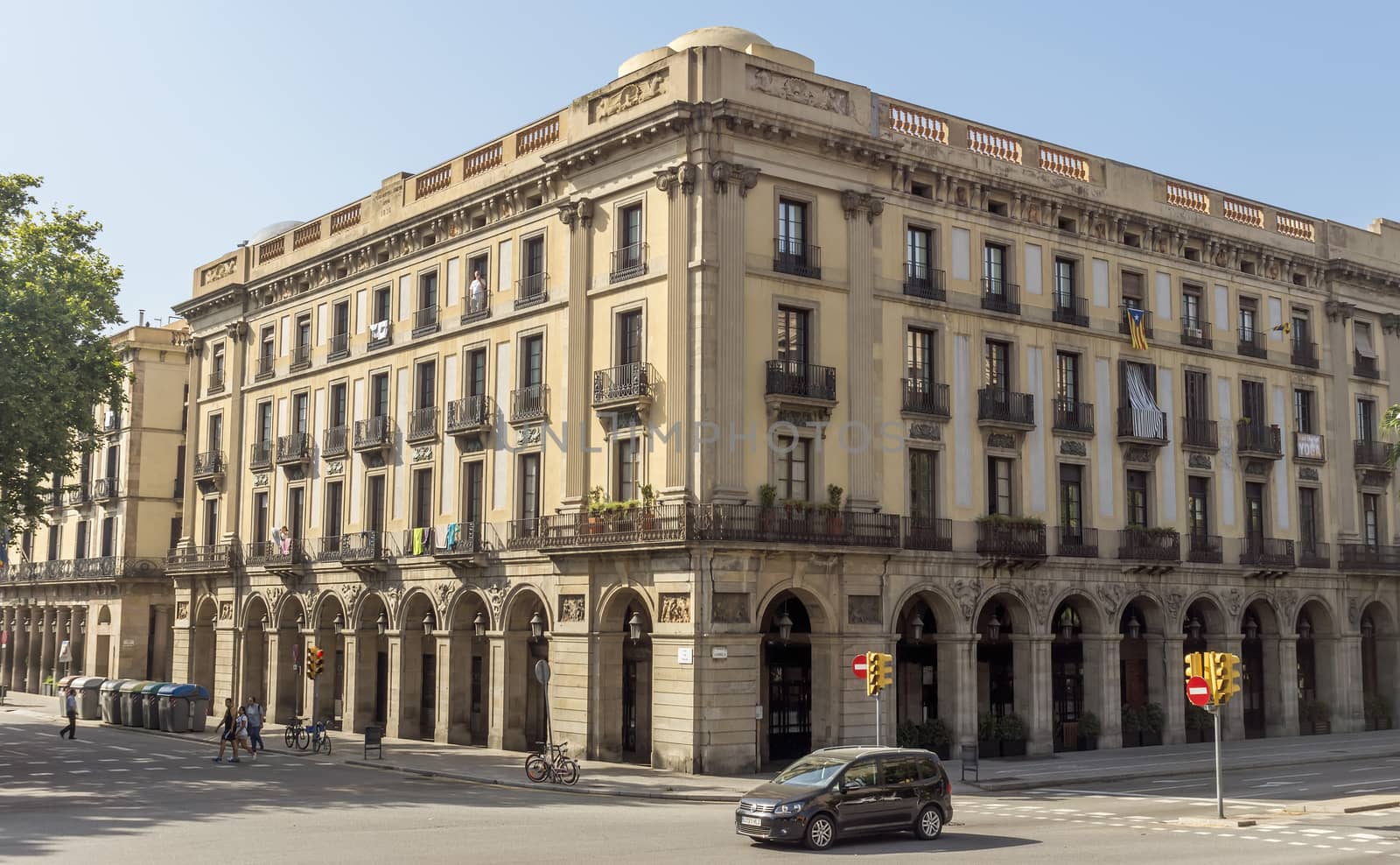 BARCELONA, SPAIN - JULY 6, 2015: Typical architecture of one urban district in Barcelona, Spain.

Barcelona, Spain - July 6, 2015: Typical architecture of one urban district in Barcelona, Spain. People are walking by street.