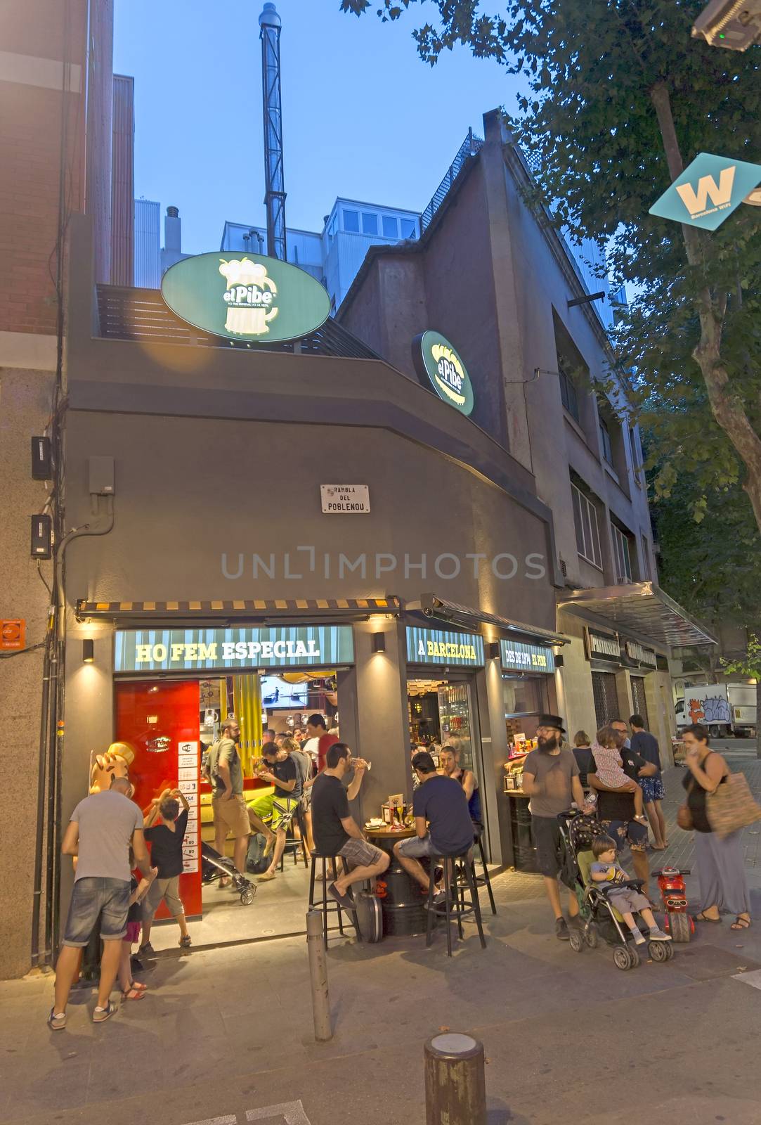 BARCELONA, SPAIN - JULY 4, 2015: Beer pub at Rambla del Poblenou in summer night - center of nightlife at Barcelona.

Barcelona, Spain - July 4, 2015: Beer pub at Rambla del Poblenou in summer night - center of nightlife at Barcelona. People are drinking.