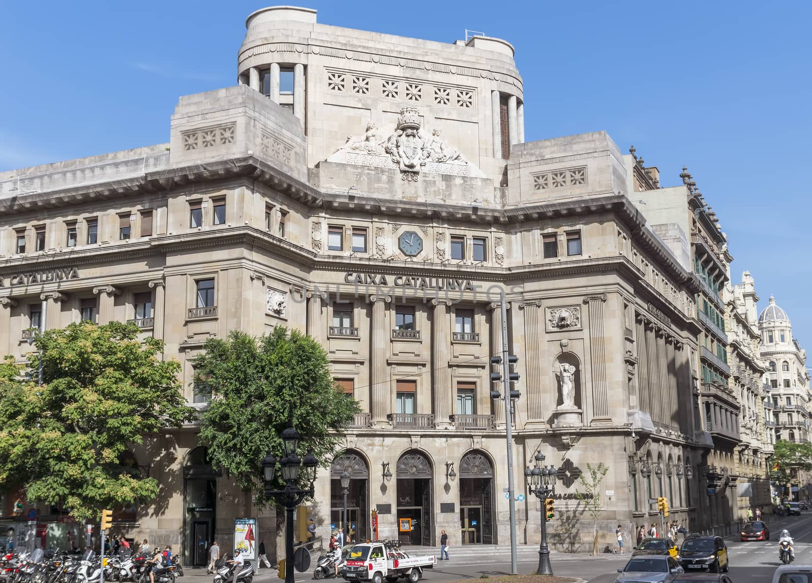 BARCELONA, SPAIN - JULY 6, 2015: Caixa Catalunya's headquarters, Barcelona, Spain. It was the fifth largest savings bank in Spain, and the second largest banking institution in Catalonia, after La Caixa. It was founded on October 26, 1926.

Barcelona, Spain - July 6, 2015: Caixa Catalunya's headquarters, Barcelona, Spain. It was the fifth largest savings bank in Spain, and the second largest banking institution in Catalonia, after La Caixa. It was founded on October 26, 1926. People are walking by street.