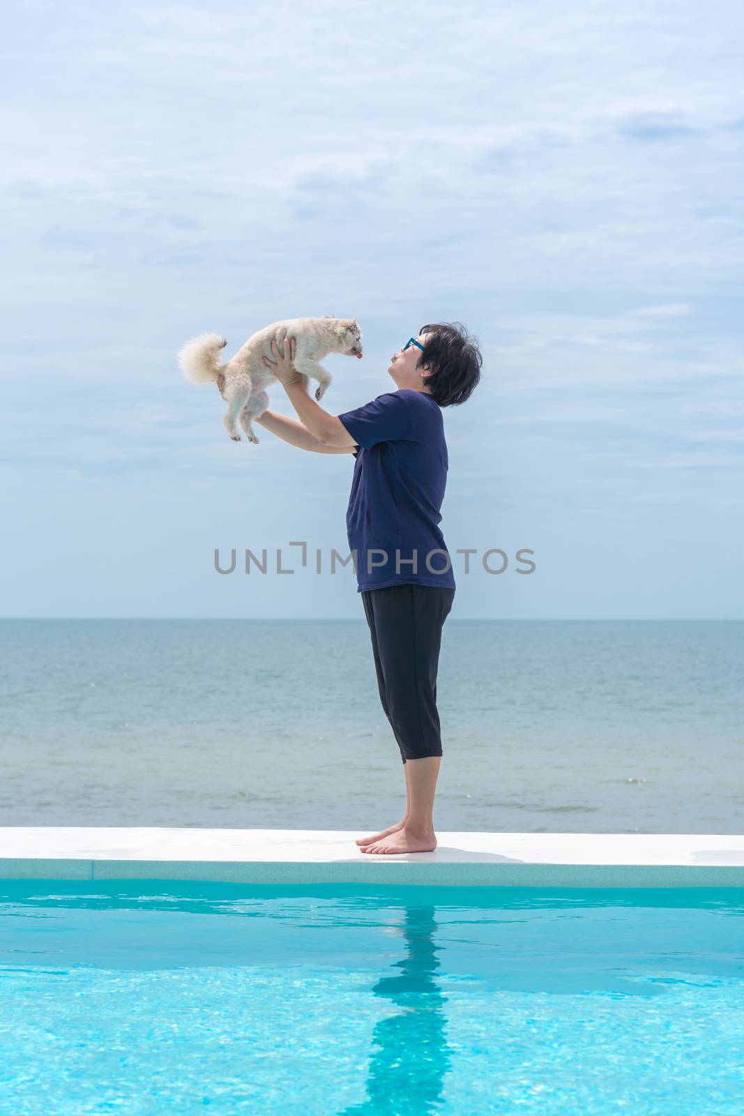 Woman and dog at outdoor swimming seaside the sea by PongMoji