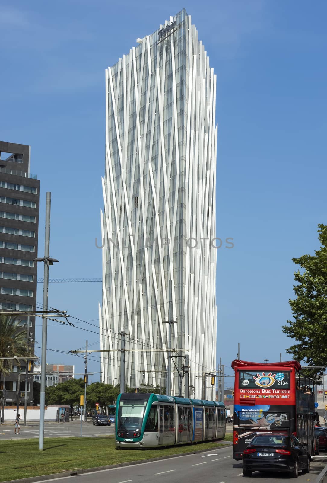 BARCELONA, SPAIN - JULY 7, 2015: New modern architecture in the Diagonal Mar i el Front Maritim del Poblenou area.

Barcelona, Spain - July 7, 2015: New modern architecture in the Diagonal Mar i el Front Maritim del Poblenou area. This is a new booming area with modern buildings. Diagonal Mar - District, built at the end of the past - the beginning of this century. The impetus for its development was the holding in the capital of Catalonia, the World Cultural Forum. Diagonal Mar is famous for its clean and tranquil beaches, upscale apartments and hotels. People are walking by street.