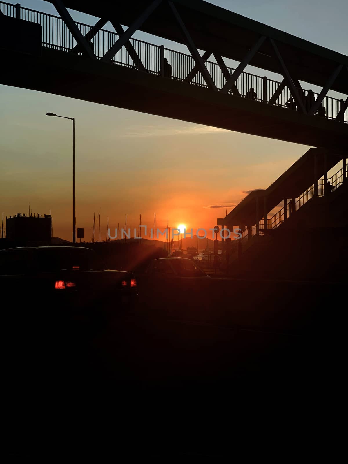 The silhouette of city bridge, road, car in Hong Kong downtown district at sunset