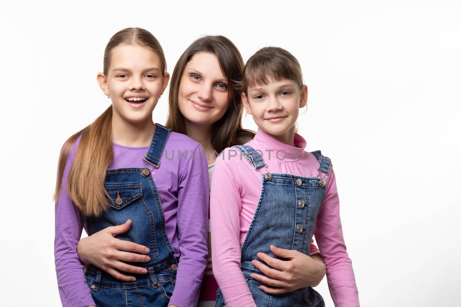 Portrait of a family, mom with two daughters, on a white background