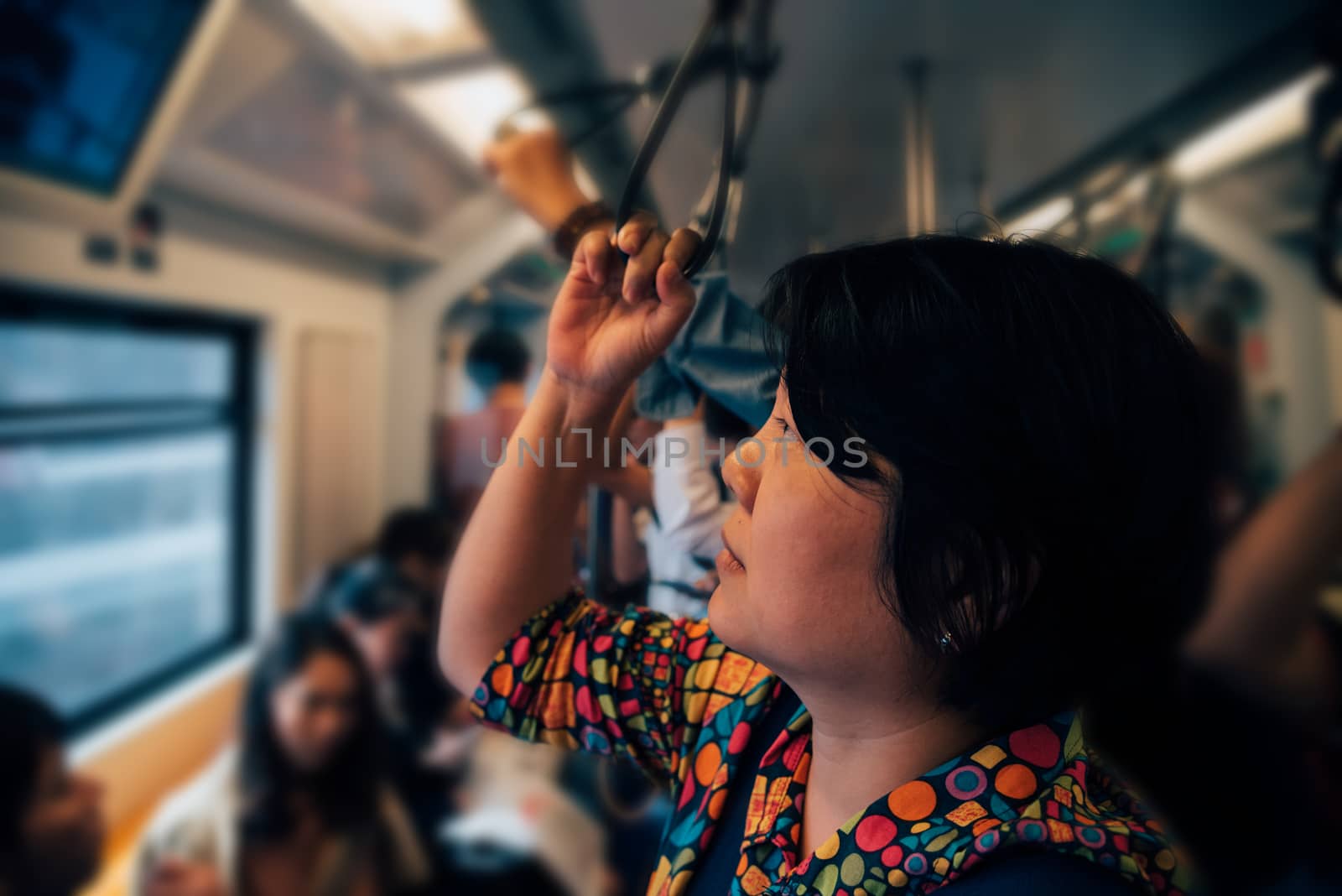 Bangkok, Thailand - January 17, 2018 : Asian woman travel on skytrain train in city. Many people in city used skytrain to save time.