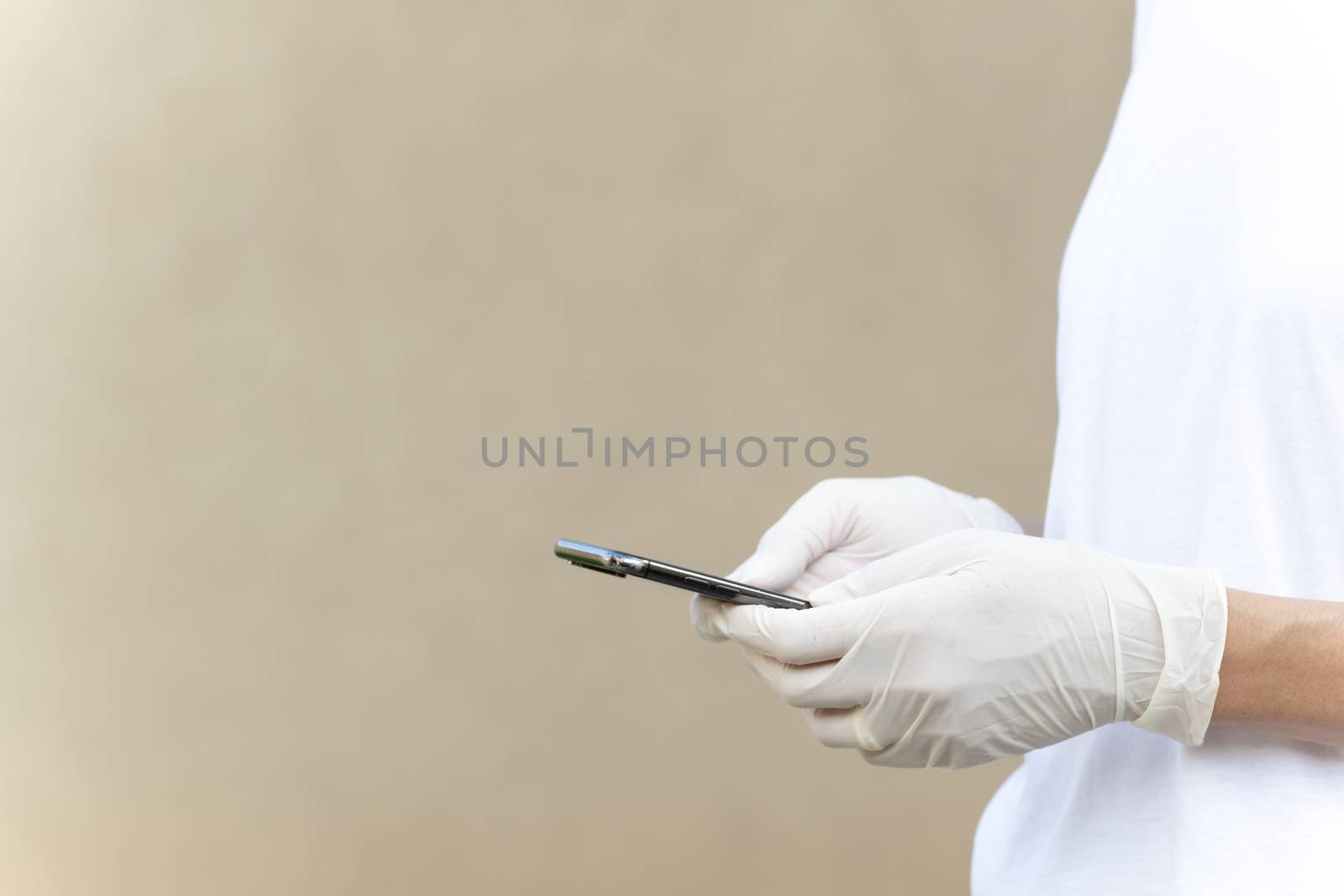 Woman wearing protective gloves and texting or chatting with her by GABIS