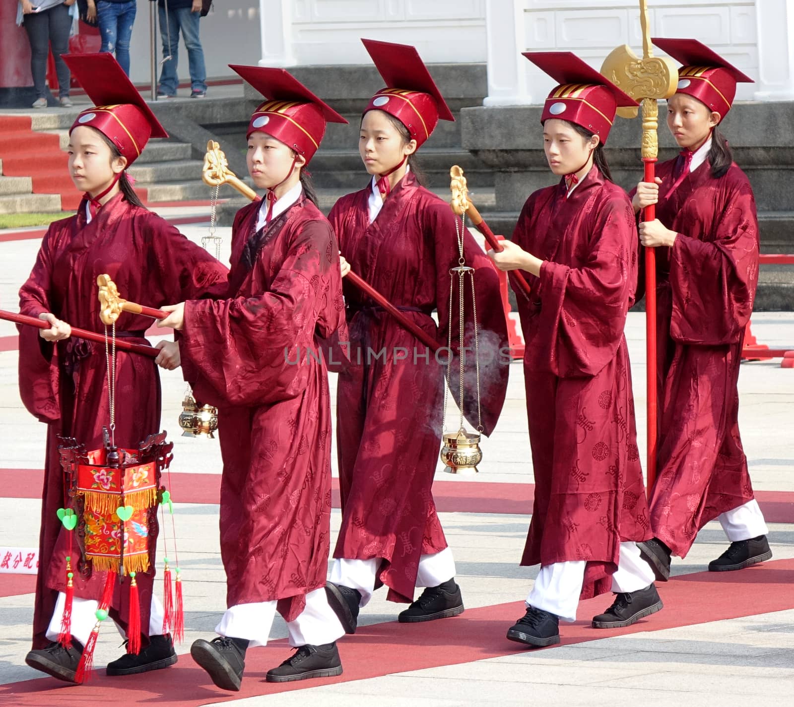 KAOHSIUNG, TAIWAN -- SEPTEMBER 28 , 2017: Ceremonial attendants in red robes take up positions for the yearly Confucius Ceremony held on Teachers Day.