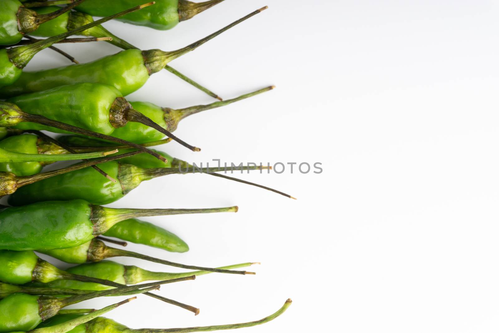 Green BirdÕs eye chili,Thai Chili pepper ,bird chili pepper nature isolate on white background. Selective focus and crop fragment