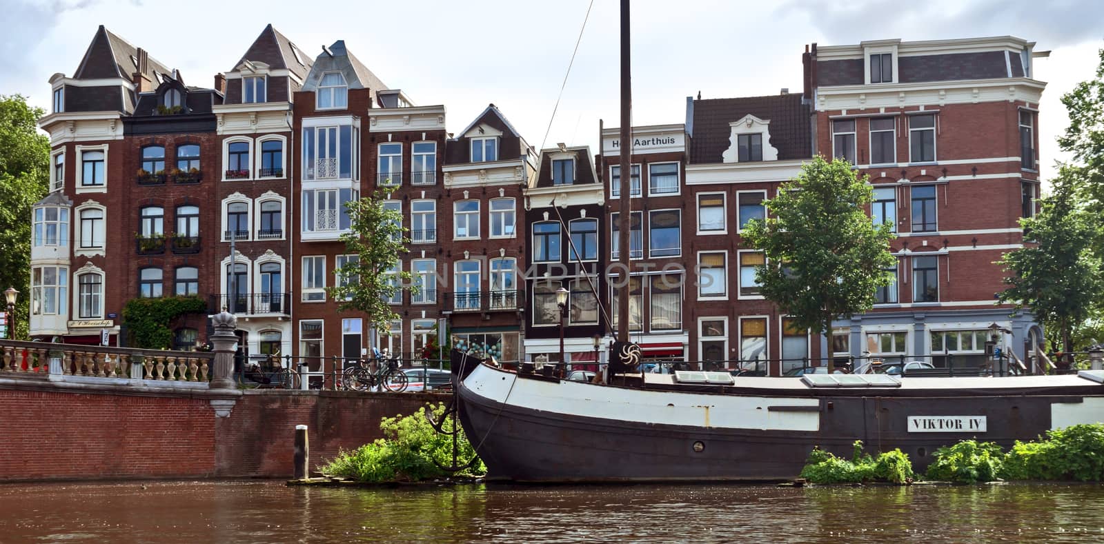 AMSTERDAM, NETHERLANDS - MAY 30: Amsterdam canals on May 30, 2014 in Amsterdam, Netherlands. View of Amsterdam canals and typical dutch houses.

Amsterdam, Netherlands - May 30, 2014: View of Amsterdam canals and typical dutch houses.