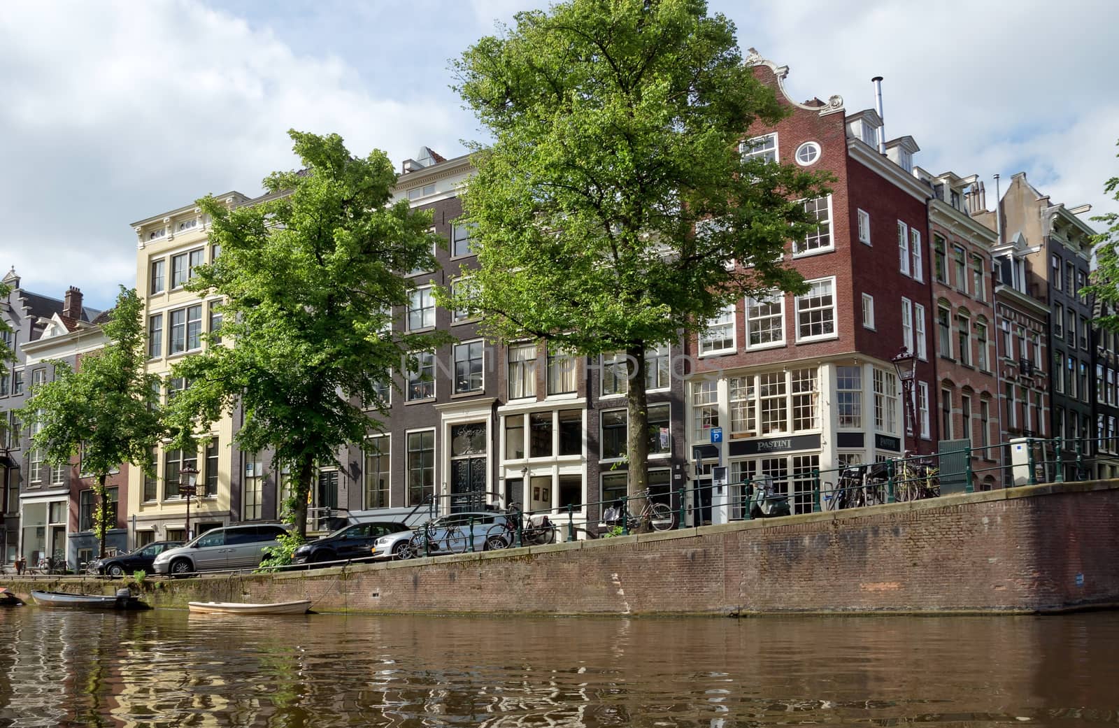 AMSTERDAM, NETHERLANDS - MAY 30: Amsterdam canals on May 30, 2014 in Amsterdam, Netherlands. View of Amsterdam canals and typical dutch houses.

Amsterdam, Netherlands - May 30, 2014: View of Amsterdam canals and typical dutch houses.