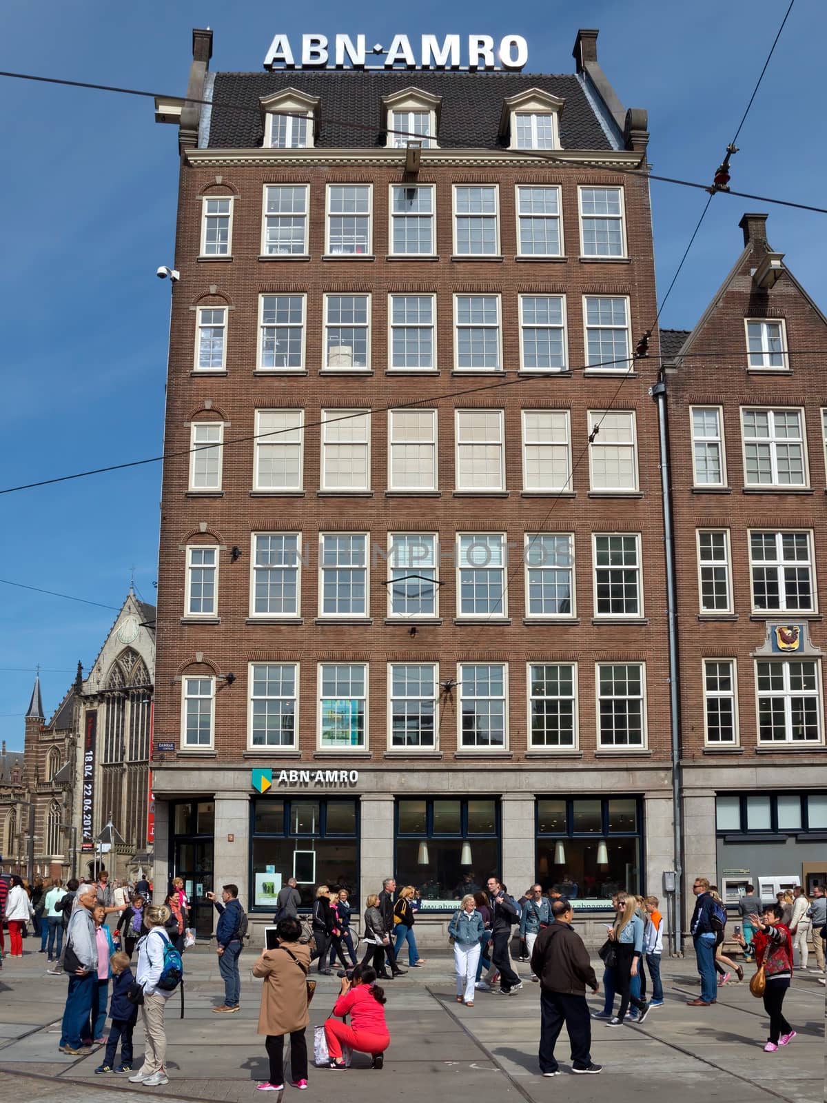 AMSTERDAM, NETHERLANDS - MAY 30: View of Amsterdam city and typical dutch houses on May 30, 2014 in Amsterdam, Netherlands.

Amsterdam, Netherlands - May 30, 2014: View of Amsterdam city and typical dutch houses. People are walking by street.