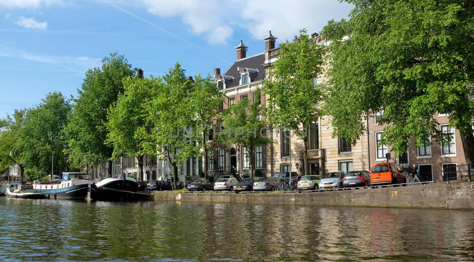 AMSTERDAM, NETHERLANDS - MAY 30: Amsterdam canals on May 30, 2014 in Amsterdam, Netherlands. View of Amsterdam canals and typical dutch houses.

Amsterdam, Netherlands - May 30, 2014: View of Amsterdam canals and typical dutch houses.