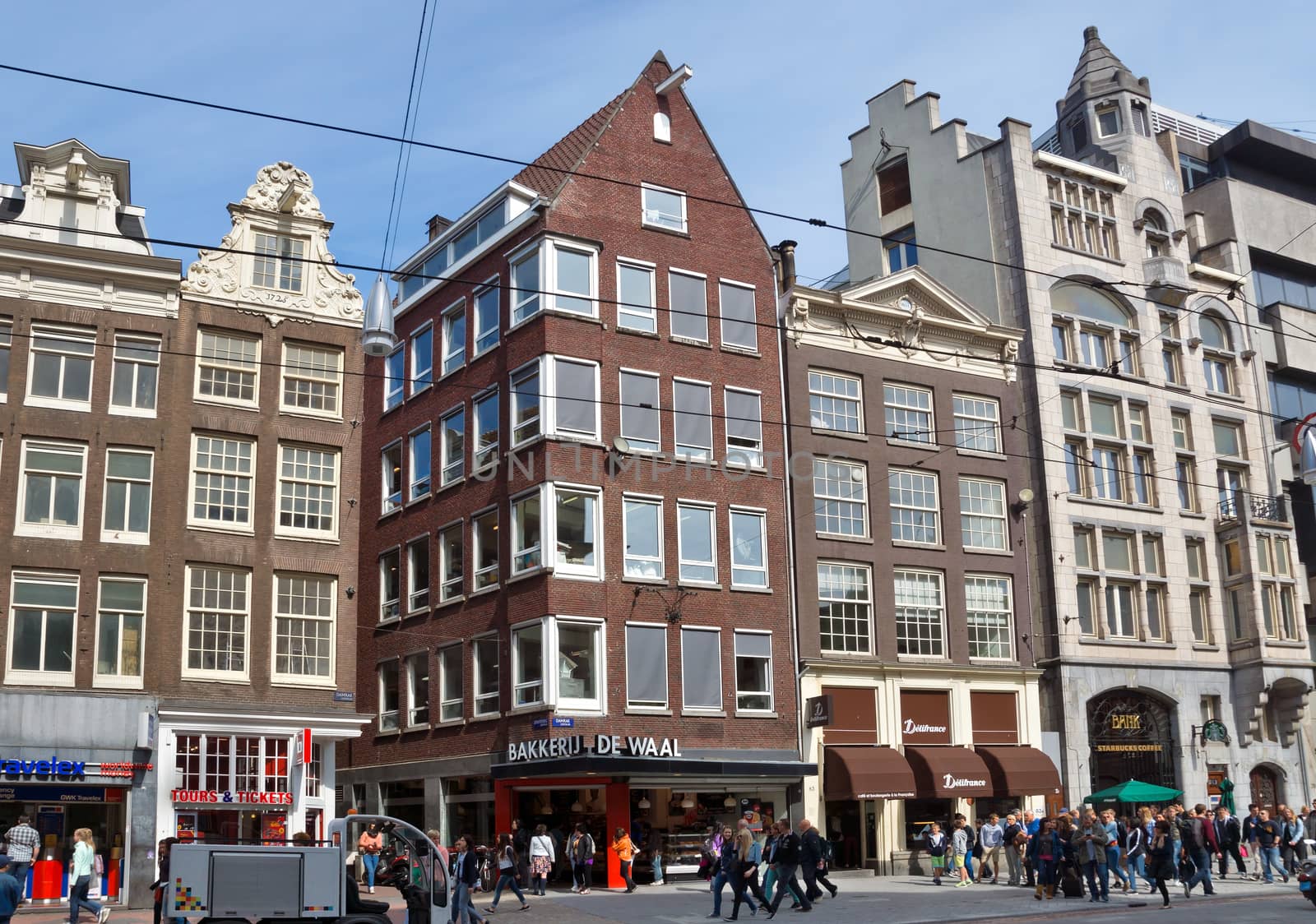 AMSTERDAM, NETHERLANDS - MAY 30: View of Amsterdam city and typical dutch houses on May 30, 2014 in Amsterdam, Netherlands.

Amsterdam, Netherlands - May 30, 2014: View of Amsterdam city and typical dutch houses. People are walking by street.