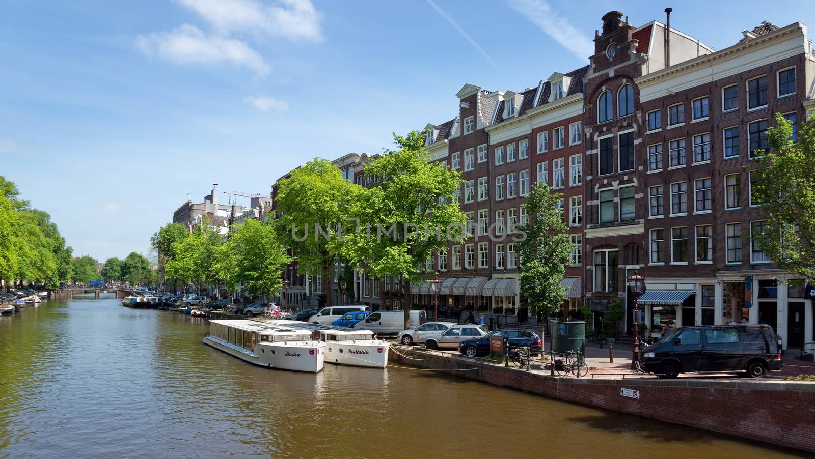 AMSTERDAM, NETHERLANDS - MAY 30: Amsterdam canals on May 30, 2014 in Amsterdam, Netherlands. View of Amsterdam canals and typical dutch houses.

Amsterdam, Netherlands - May 30, 2014: View of Amsterdam canals and typical dutch houses.