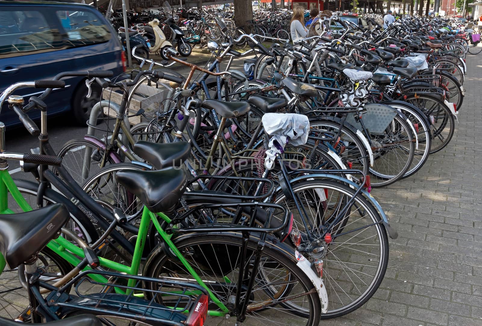 AMSTERDAM, NETHERLANDS - MAY 30: Amsterdam Central station. Many bicycles parked near of the Central station on May 30, 2014 in Amsterdam, Netherlands.

Amsterdam, Netherlands - May 30, 2014: Amsterdam Central station. Many bicycles parked near of the Central station.