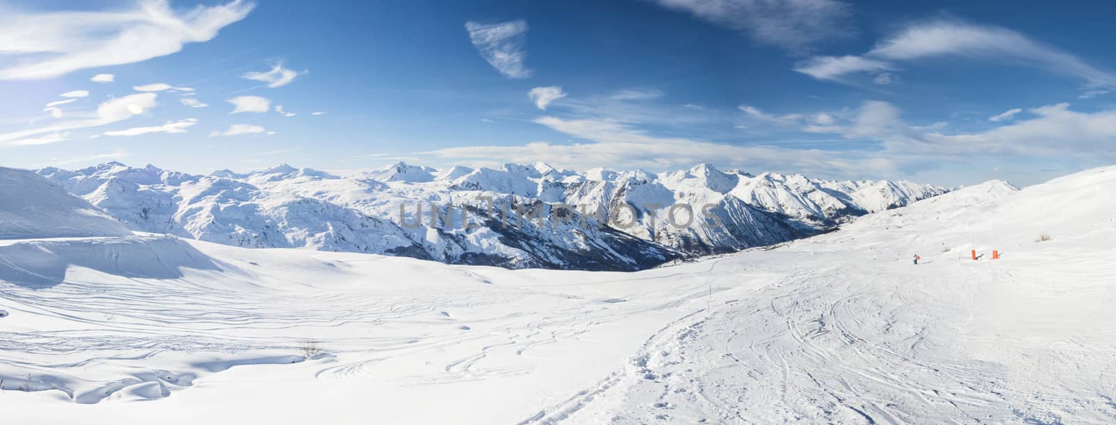 Panoramic view down snow covered valley in alpine mountain range by paulvinten