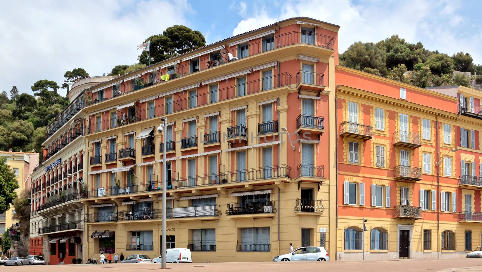 NICE, FRANCE - MAY 31: Architecture along Promenade des Anglais on May 31, 2014 in Nice, France. Promenade is a symbol of the Cote d'Azur and was built in 1830 at the expense of the British colony.

Nice, France - May 31, 2014: Architecture along Promenade des Anglais. Promenade des Anglais is a symbol of the Cote d'Azur and was built in 1830 at the expense of the British colony. People are walking by street.