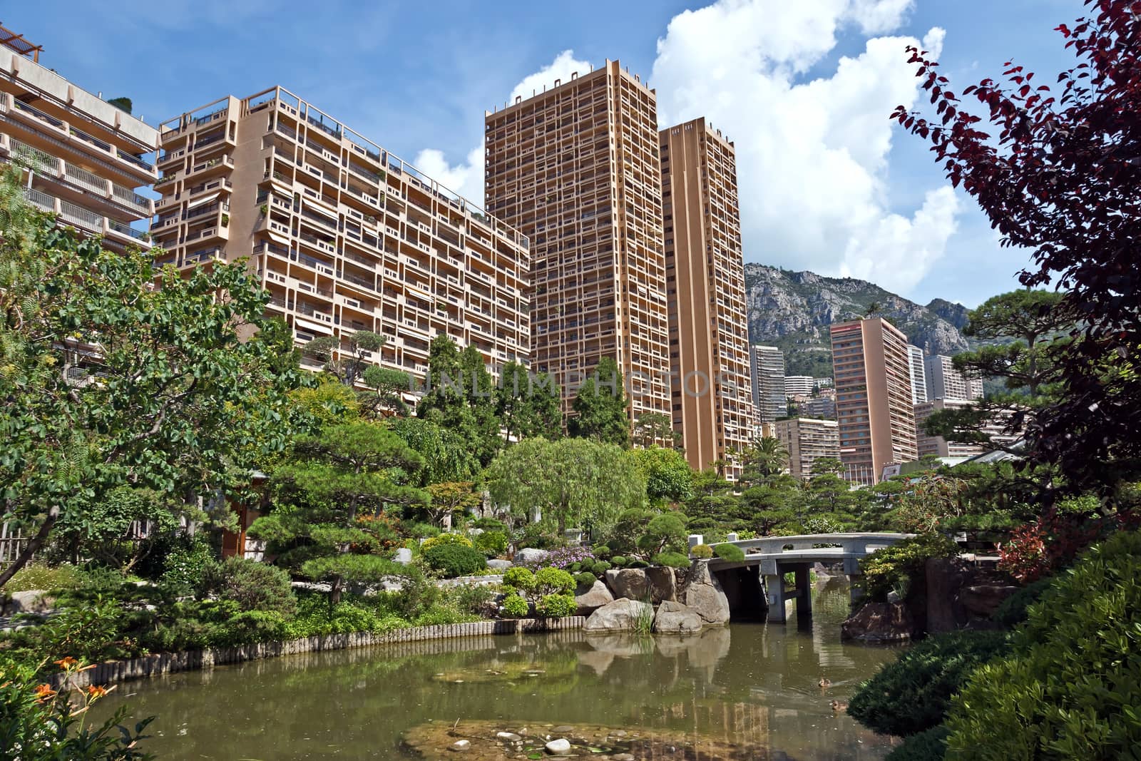 MONTE CARLO, MONACO - JUNE 1, 2014: View of Monte Carlo buildings from Japanese garden of Monaco.

Monte Carlo, Monaco - June 1, 2014: View of Monte Carlo buildings from Japanese garden of Monaco.
