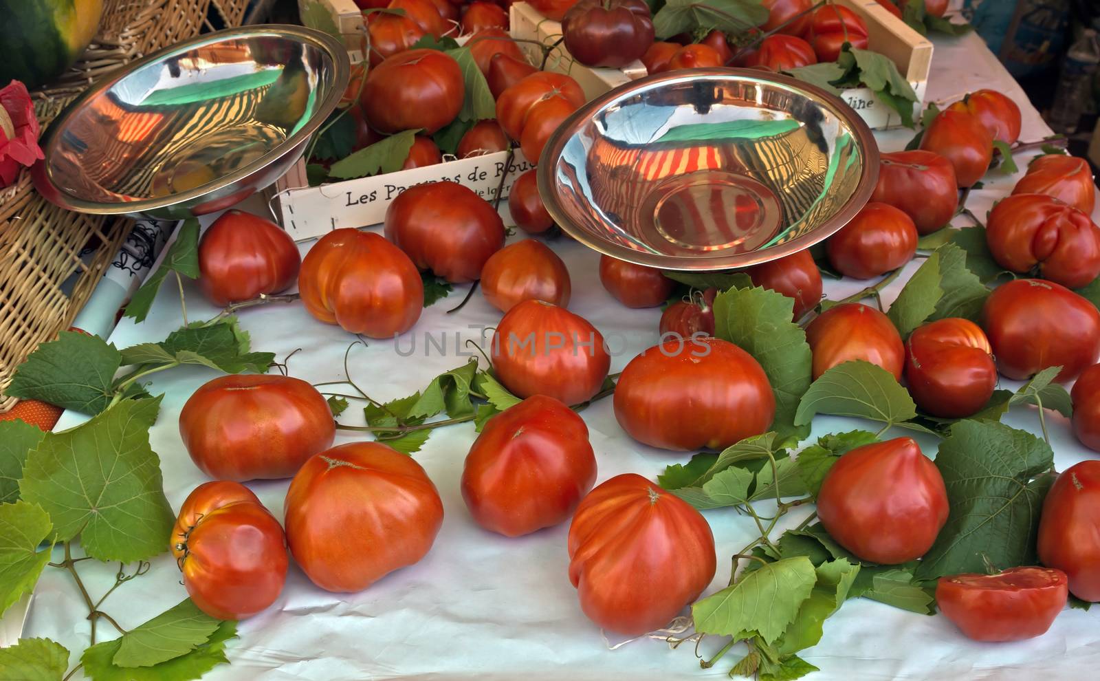 Tomatoes with green leaves at French market. Taken at the Cours Saleya in Nice France.