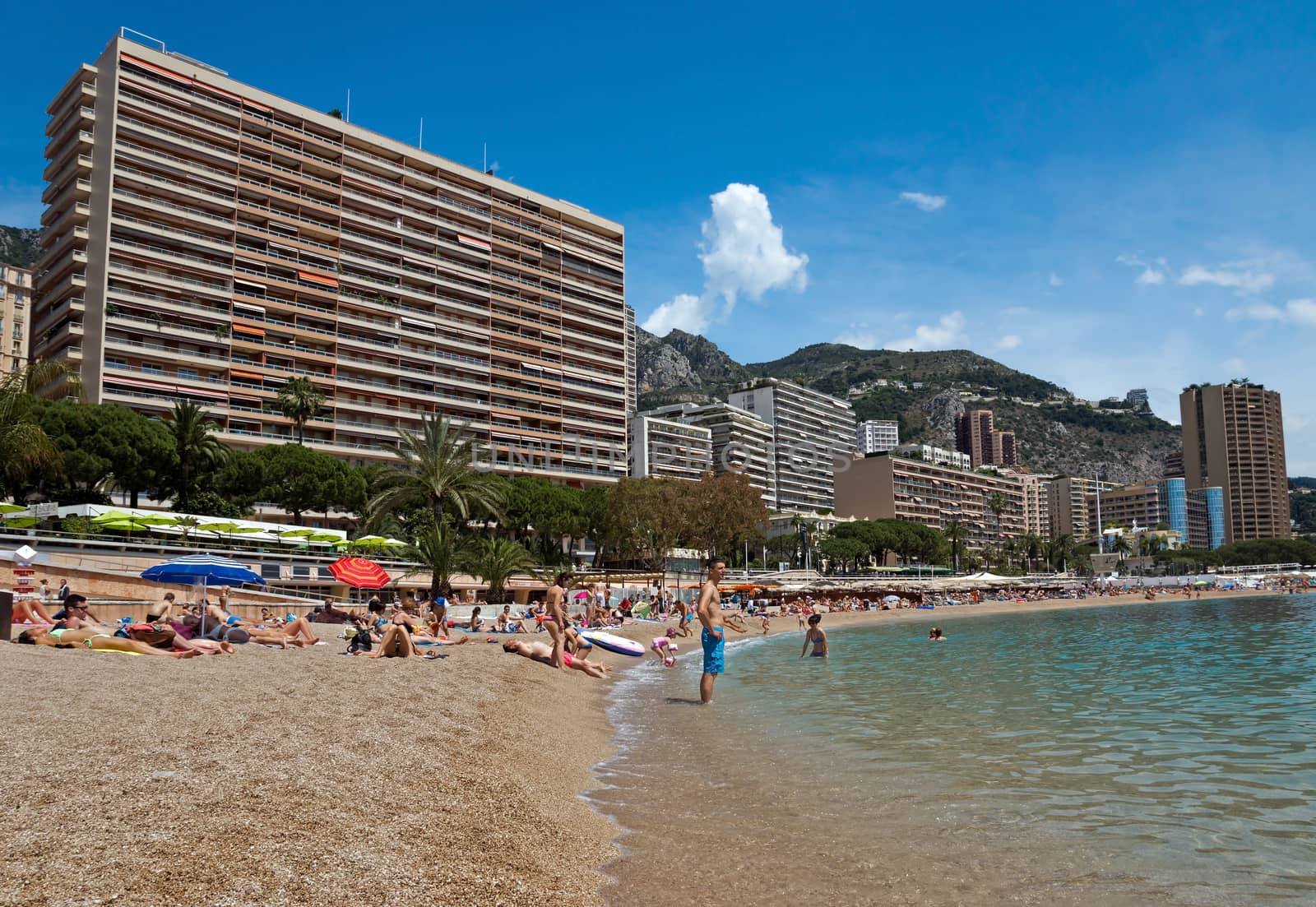 MONTE CARLO, MONACO - JUNE 1, 2014: Architecture of residential buildings from the city beach.

Monte Carlo, Monaco - June 1, 2014: Architecture of residential buildings from the city beach. People are taking a sunbath, sunbathing and swiming.
