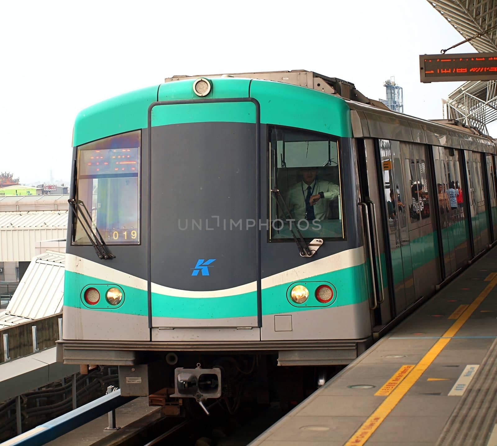 QIAOTOU, TAIWAN -- NOVEMBER 24, 2013: A train of the Kaohsiung Mass Rapid Transit System pulls into Qiaotou station.
